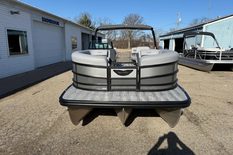 Slide: The Image of 2026 Bennington 24 M Sport Lounge Quad Bench pontoon boat outside showroom. - 2