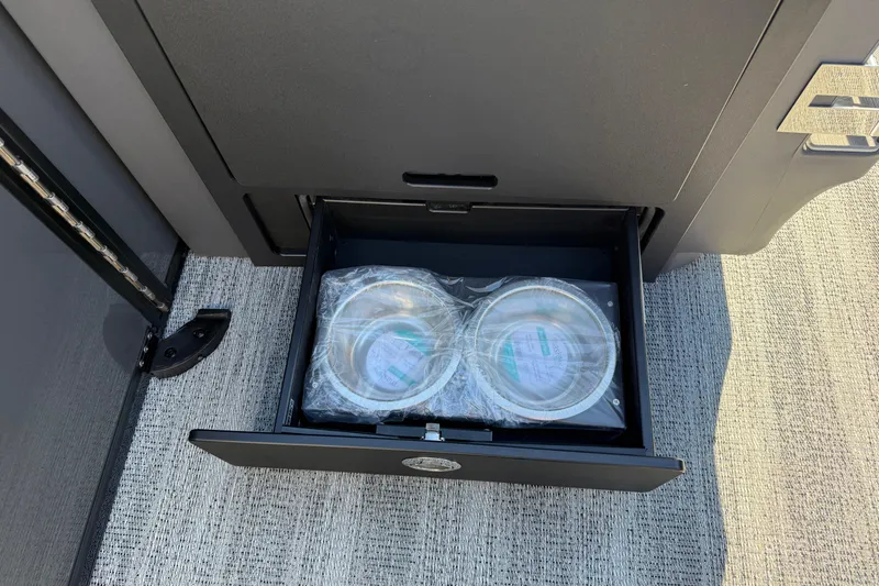 Slide: The Image of Open drawer with packaged items on Bennington 24 M Sport Lounge Quad Bench, 2026 model. - 21