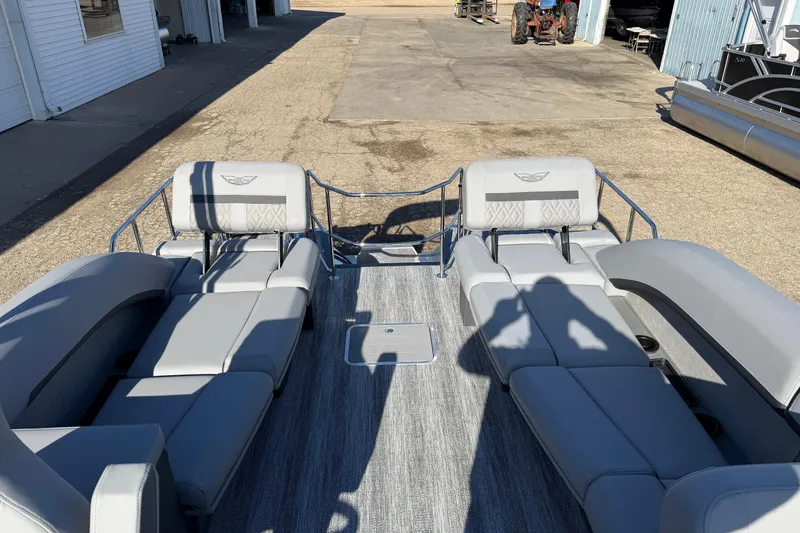 Slide: The Image of 2026 Bennington 24 M Sport Lounge Quad Bench with gray seating and open deck layout. - 25