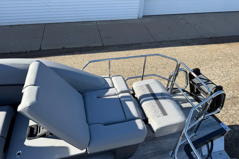 Slide: The Image of 2026 Bennington 24 M Sport Lounge Quad Bench with sleek gray seating and metal railings. - 28