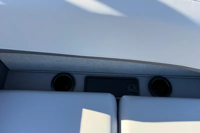 Slide: The Image of 2026 Bennington 24 M Sport Lounge Quad Bench interior with cup holders and storage. - 29