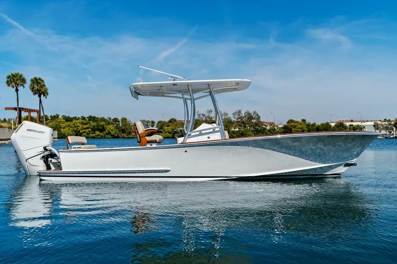 The Image of 2024 Custom Center Console High Ground Boatworks on calm water, featuring sleek design and Mercury engine. - 1