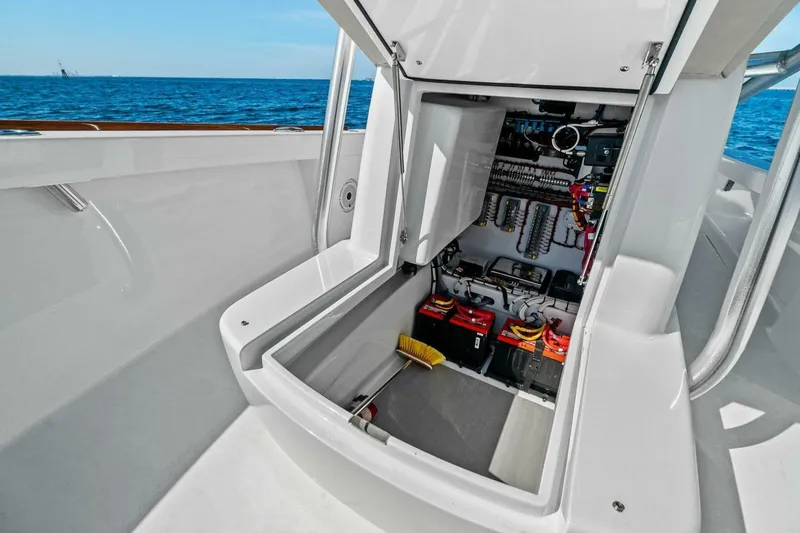 Slide: The Image of 2024 Custom Center Console High Ground Boatworks with open storage compartment, ocean view. - 12