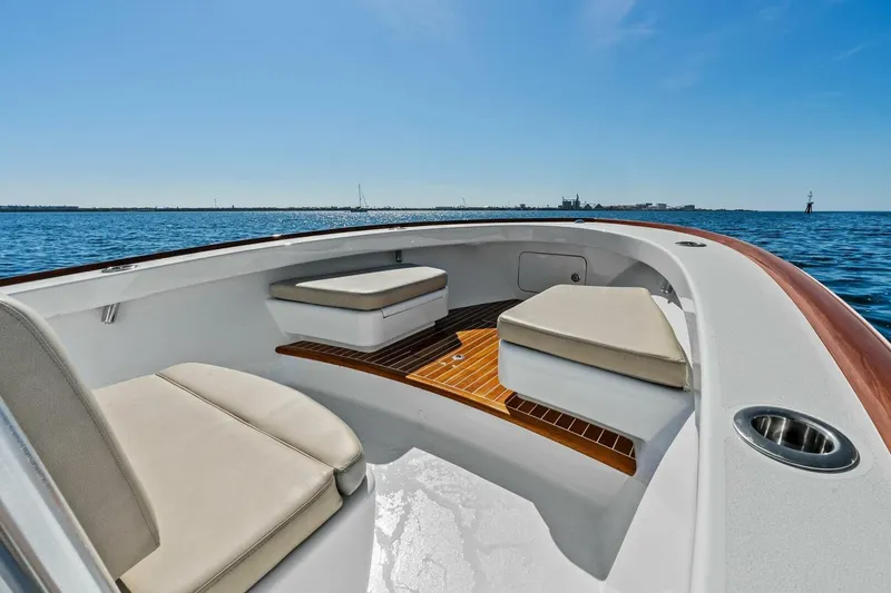 Slide: The Image of 2024 Custom Center Console High Ground Boatworks on open water, featuring cushioned seating. - 13