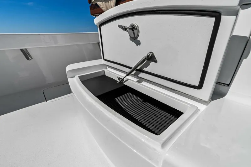 Slide: The Image of 2024 Custom Center Console High Ground Boatworks with open storage compartment. - 16