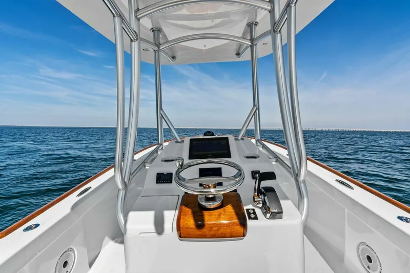 Slide: The Image of 2024 Custom Center Console High Ground Boatworks on open water, featuring sleek design and modern controls. - 18