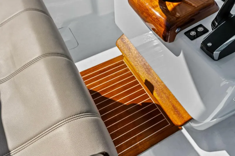 Slide: The Image of 2024 Custom Center Console High Ground Boatworks interior with leather seating and wooden accents. - 21