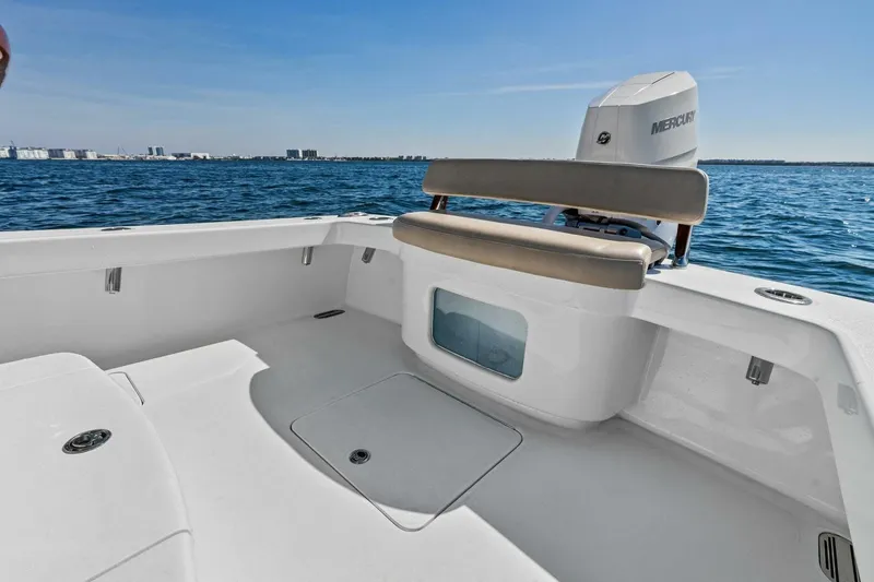 Slide: The Image of 2024 Custom Center Console High Ground Boatworks on open water, featuring spacious seating and Mercury engine. - 24