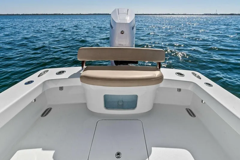 Slide: The Image of 2024 Custom Center Console High Ground Boatworks on open water, featuring a sleek seating area. - 25