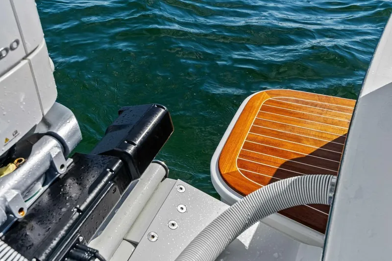 Slide: The Image of 2024 Custom Center Console High Ground Boatworks with wooden deck and motor, on water. - 29