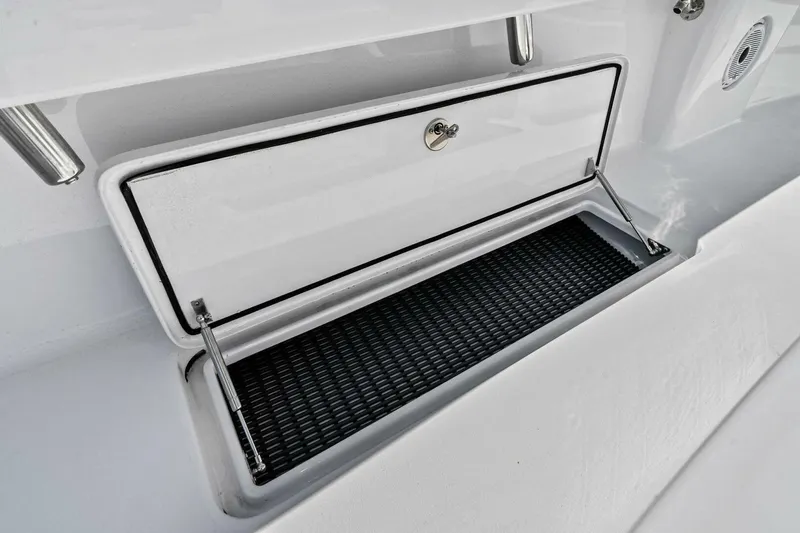 Slide: The Image of 2024 Custom Center Console High Ground Boatworks storage compartment with open hatch. - 32
