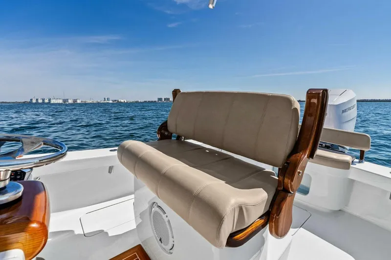 Slide: The Image of 2024 Custom Center Console High Ground Boatworks on open water, featuring comfortable seating. - 4