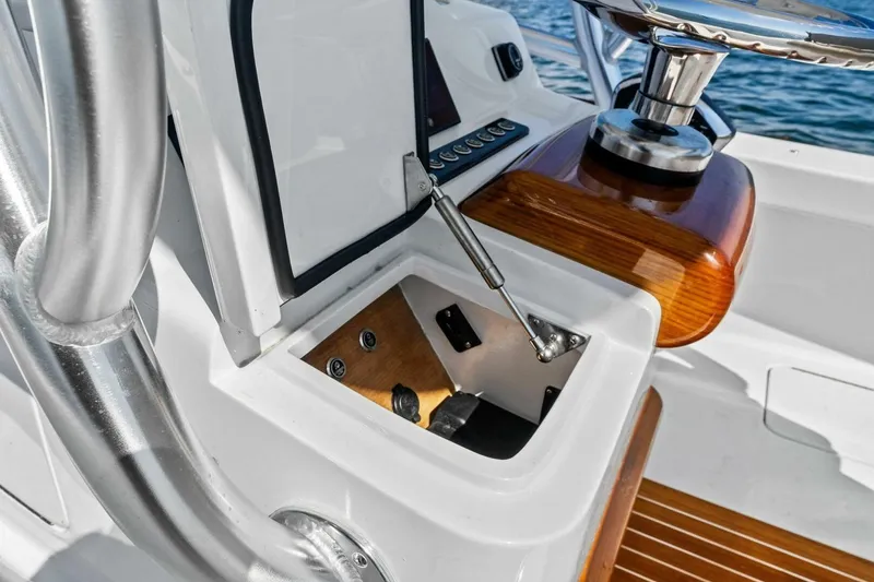 Slide: The Image of 2024 Custom Center Console High Ground Boatworks interior with wood accents and control panel. - 41