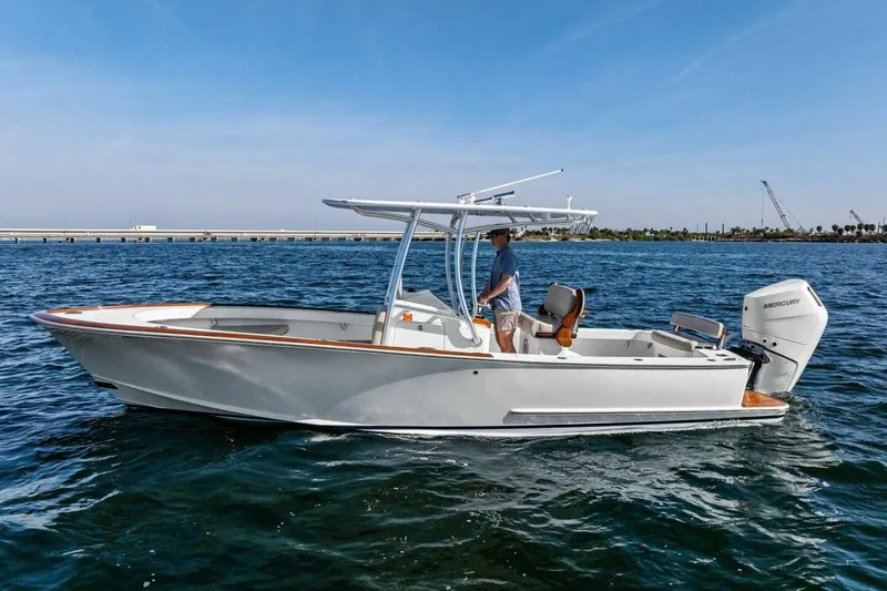 Slide: The Image of 2024 Custom Center Console High Ground Boatworks on water, featuring sleek design and Mercury engine. - 46