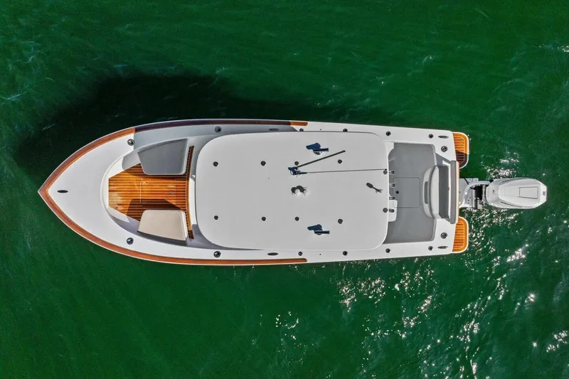 Slide: The Image of Aerial view of 2024 Custom Center Console High Ground Boatworks on green water. - 50