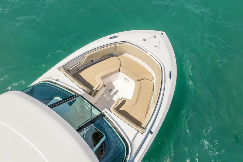 Slide: The Image of 2017 Pursuit DC 325 Dual Console boat with beige seating on turquoise water. - 10