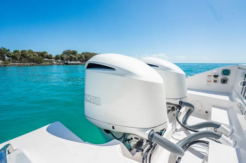 Slide: The Image of 2017 Pursuit DC 325 Dual Console with Yamaha engines on turquoise water. - 23