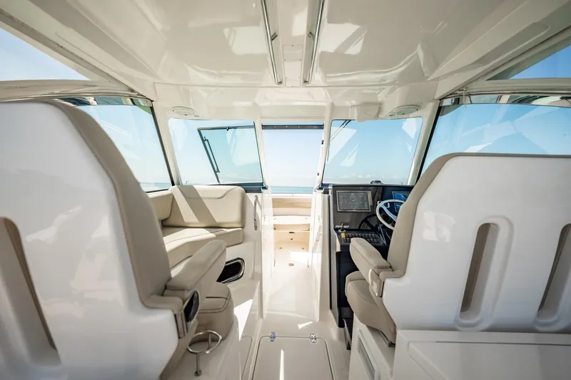 Slide: The Image of 2017 Pursuit DC 325 Dual Console interior with modern seating and navigation controls. - 31