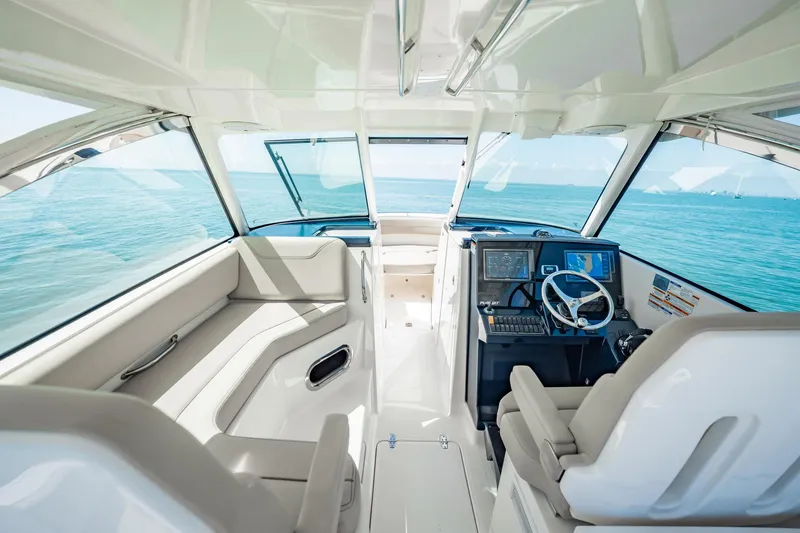 Slide: The Image of 2017 Pursuit DC 325 Dual Console interior with ocean view, featuring modern navigation equipment. - 32