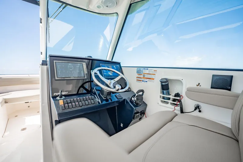 Slide: The Image of 2017 Pursuit DC 325 Dual Console boat interior with modern dashboard and steering wheel. - 33