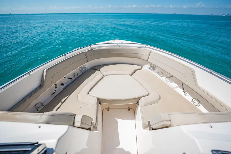 Slide: The Image of 2017 Pursuit DC 325 Dual Console boat interior with beige seating on blue ocean. - 35