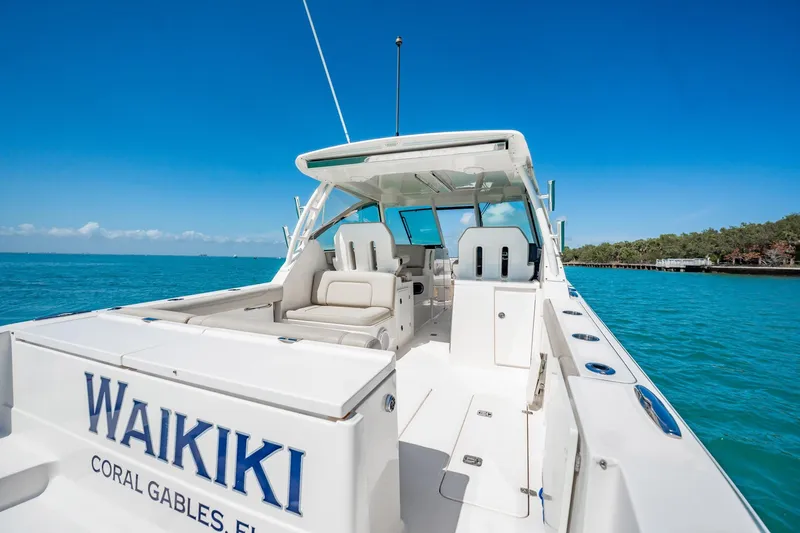 Slide: The Image of 2017 Pursuit DC 325 Dual Console boat on turquoise water, labeled "Waikiki," Coral Gables, Florida. - 43