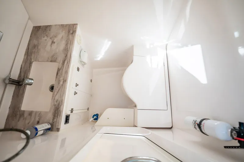 Slide: The Image of 2017 Pursuit DC 325 Dual Console interior with sink and storage compartments. - 46