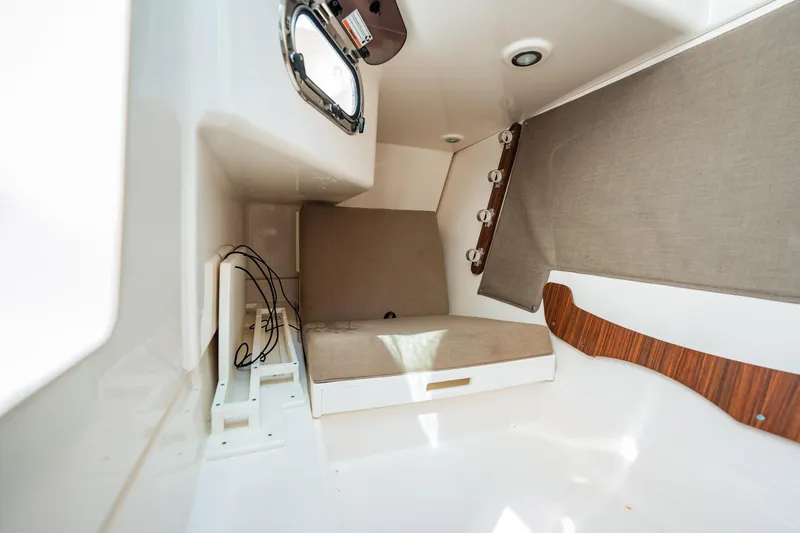 Slide: The Image of 2017 Pursuit DC 325 Dual Console cabin interior with seating and storage. - 47