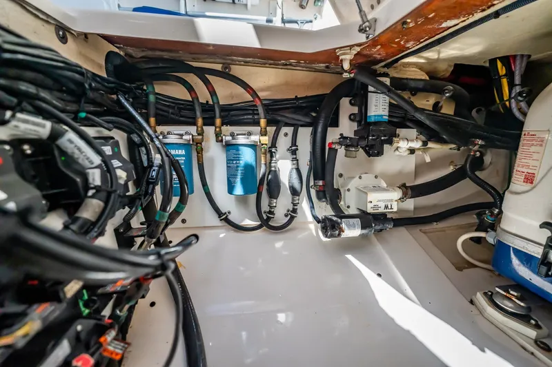 Slide: The Image of 2017 Pursuit DC 325 Dual Console engine compartment with wiring and filtration systems. - 50