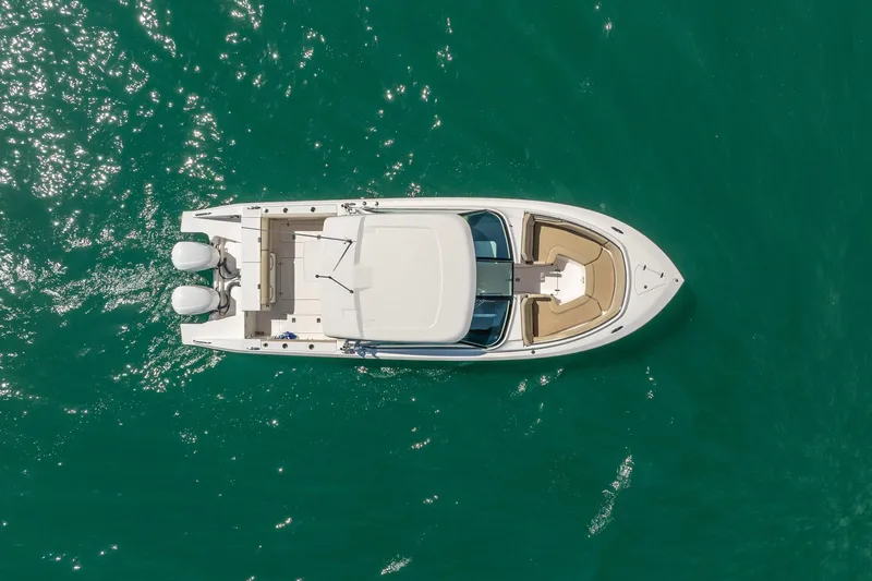 Slide: The Image of Overhead view of 2017 Pursuit DC 325 Dual Console boat on turquoise water. - 53