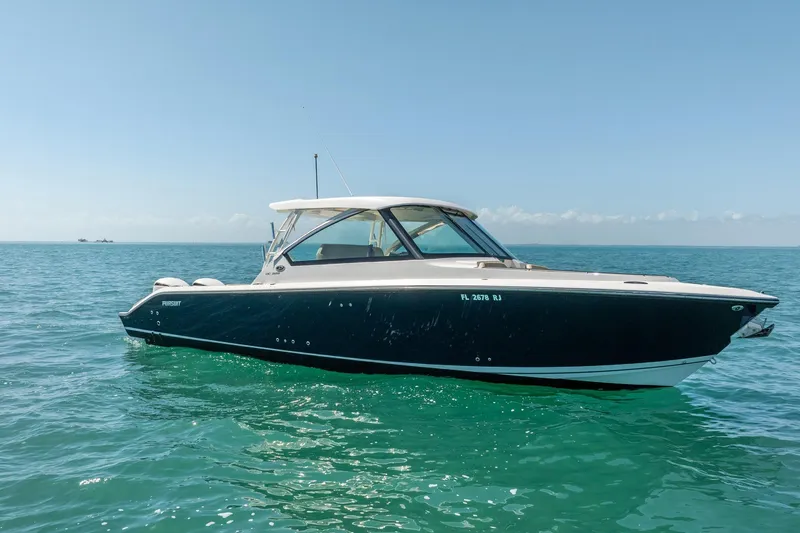 Slide: The Image of 2017 Pursuit DC 325 Dual Console boat on clear blue ocean water. - 59