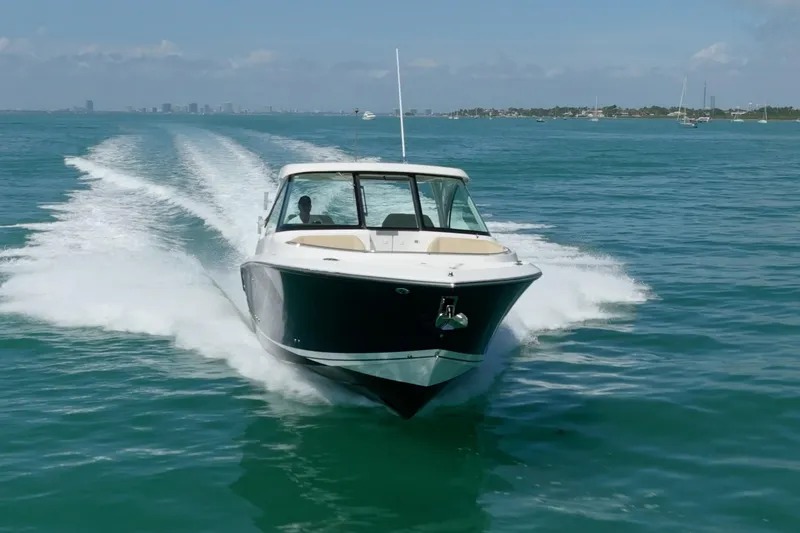 Slide: The Image of 2017 Pursuit DC 325 Dual Console boat cruising on open water. - 69