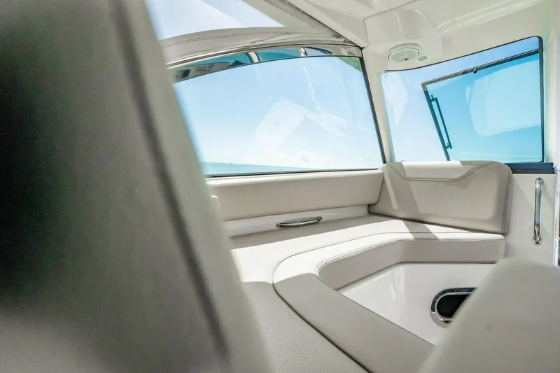 Slide: The Image of Interior view of 2017 Pursuit DC 325 Dual Console boat with cushioned seating. - 72