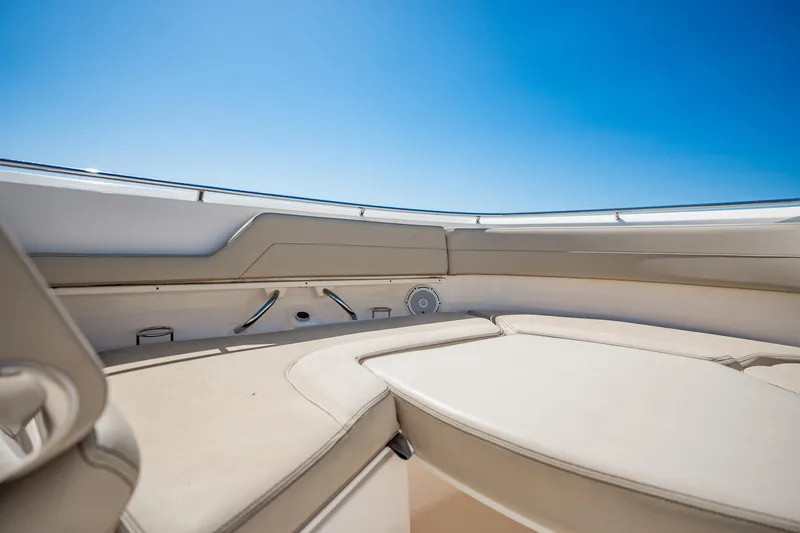 Slide: The Image of 2017 Pursuit DC 325 Dual Console boat interior with beige seating under clear blue sky. - 73