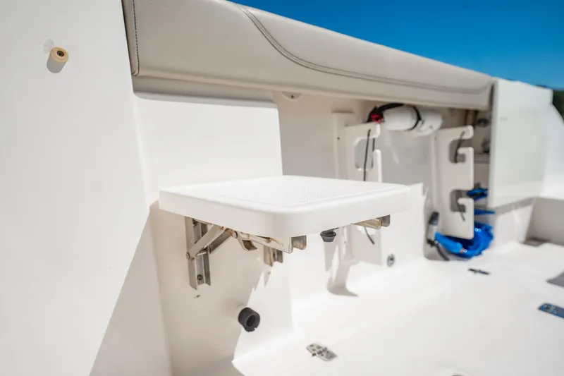 Slide: The Image of 2017 Pursuit DC 325 Dual Console boat interior with foldable seat and storage features. - 79