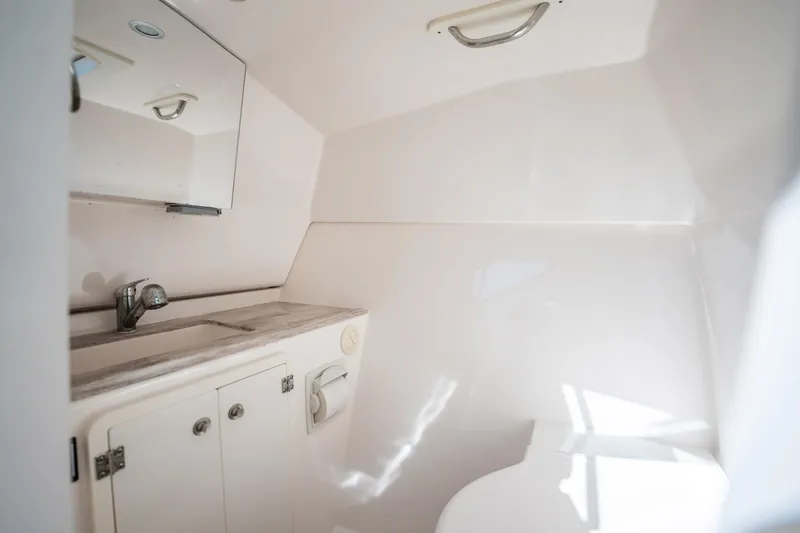 Slide: The Image of 2017 Pursuit DC 325 Dual Console boat interior bathroom with sink and mirror. - 89