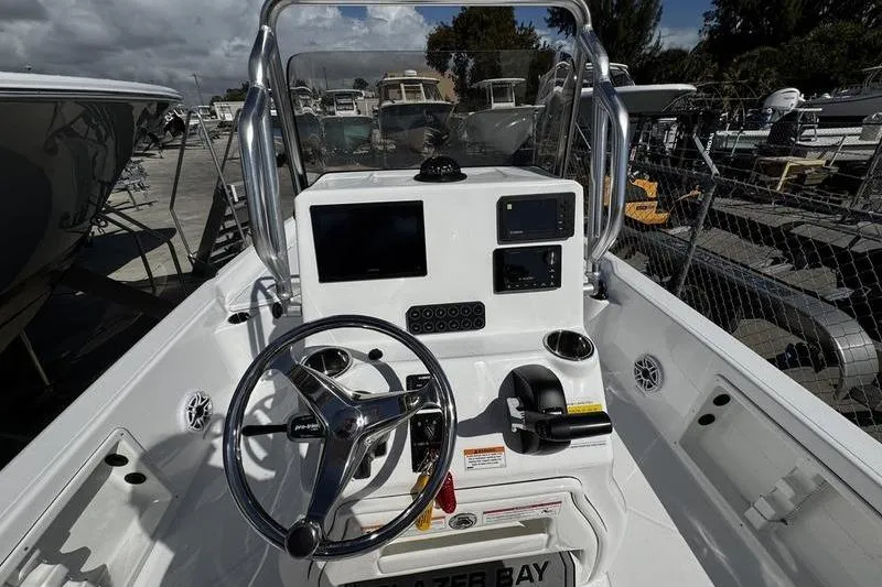 Slide: The Image of 2026 Blazer PureBay 2200 boat console with steering wheel and navigation equipment. - 18