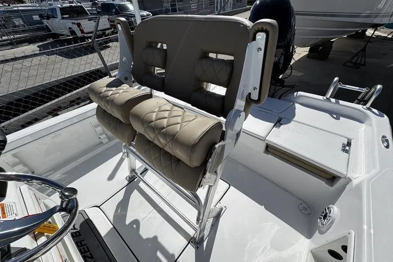 Slide: The Image of 2026 Blazer PureBay 2200 boat interior with cushioned seating and steering wheel. - 21