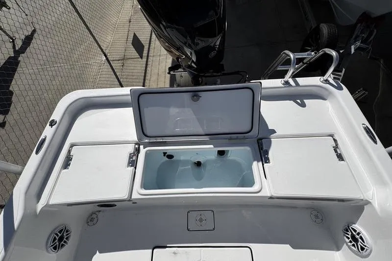 Slide: The Image of 2026 Blazer PureBay 2200 boat deck with storage compartments and motor. - 28