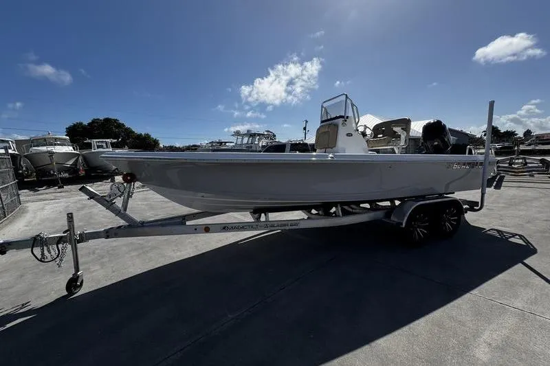 Slide: The Image of 2026 Blazer PureBay 2200 boat on trailer under clear blue sky. - 4