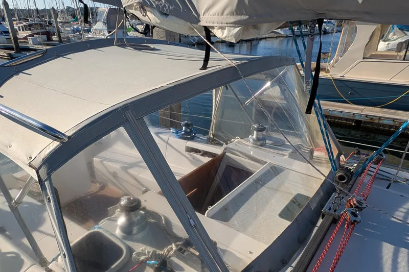 Slide: The Image of 2003 Catalina 34 MkII sailboat cockpit with protective canopy in marina setting. - 10