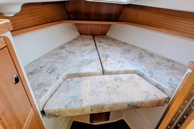 Slide: The Image of Interior view of 2003 Catalina 34 MkII sailboat cabin with V-berth bedding. - 11