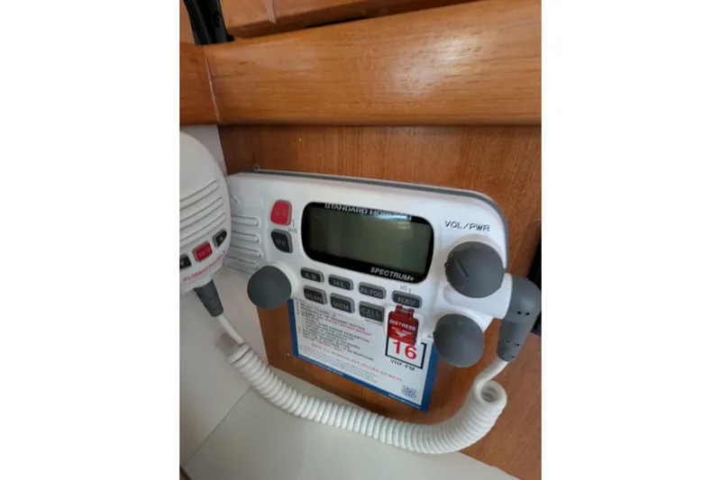 Slide: The Image of VHF marine radio on 2003 Catalina 34 MkII sailboat, featuring control panel and microphone. - 16