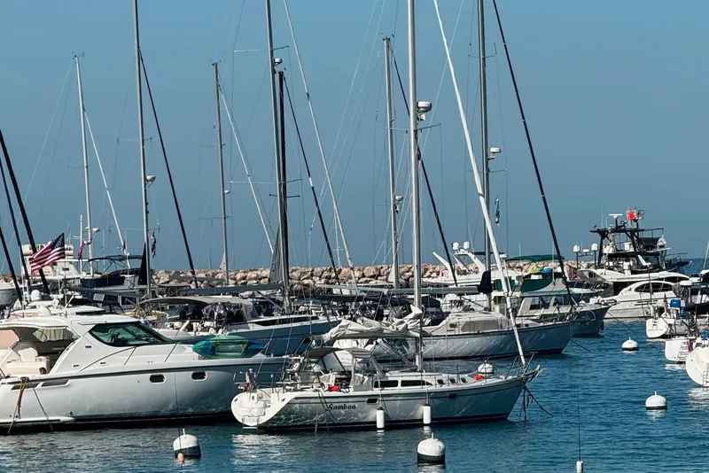 Slide: The Image of Boats docked in a marina, featuring a 2003 Catalina 34 MkII sailboat. - 2
