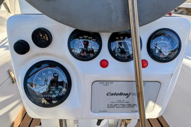 Slide: The Image of Instrument panel of a 2003 Catalina 34 MkII sailboat, featuring gauges and controls. - 22