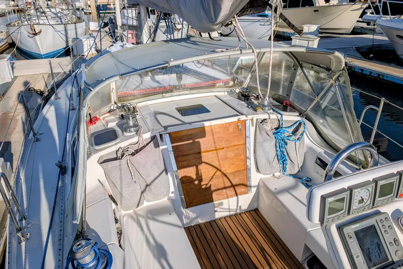 Slide: The Image of 2003 Catalina 34 MkII sailboat cockpit with wooden flooring and navigation instruments. - 25