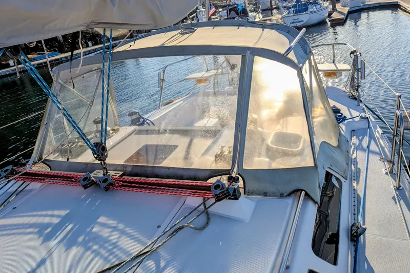 Slide: The Image of 2003 Catalina 34 MkII sailboat docked at marina, featuring cockpit and rigging. - 26
