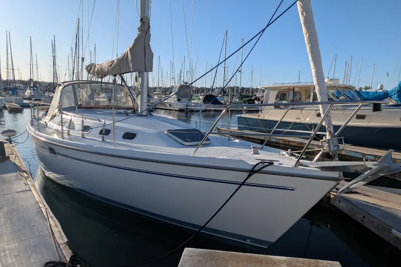 Slide: The Image of 2003 Catalina 34 MkII sailboat docked in a marina under clear blue skies. - 27