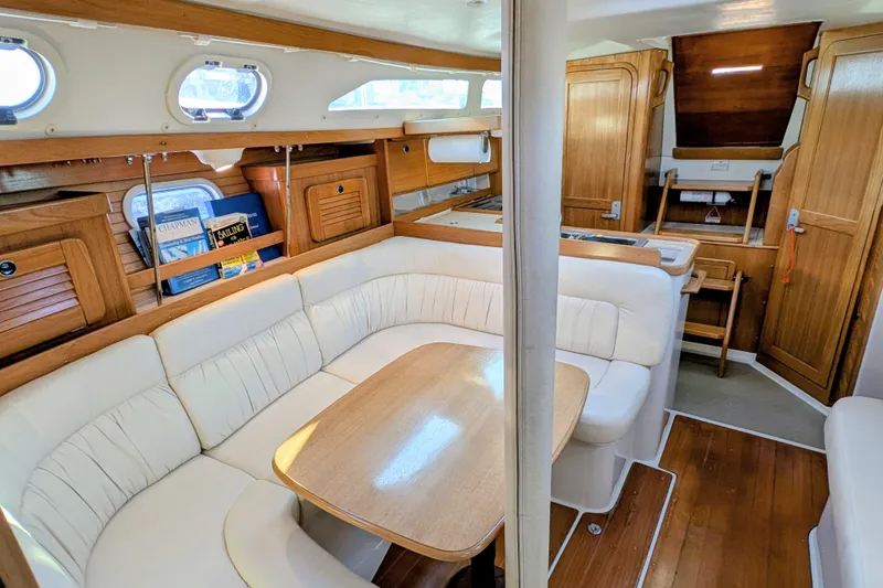 Slide: The Image of Interior of 2003 Catalina 34 MkII sailboat with cozy seating and wooden cabinetry. - 5