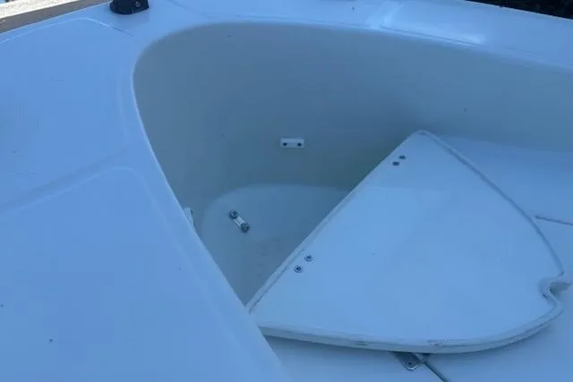 Slide: The Image of 2024 Rigid Boats 10 Sport storage compartment with open hatch, showcasing interior space. - 13